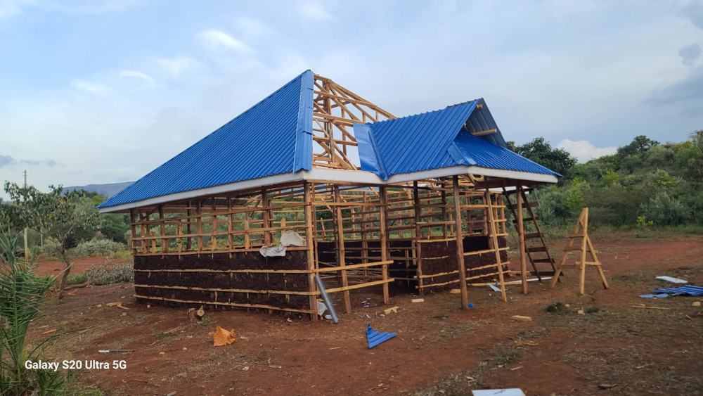 Blue iron sheets going on over timber framing