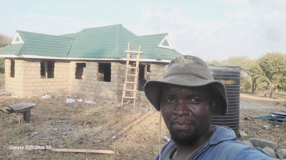 On site: green tile-profile roof completed